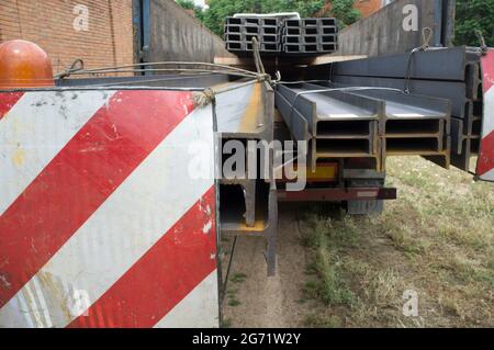 Camion de matériaux de construction chargé de poutres en acier. Notion : restrictions de longueur de charge surdimensionnée Banque D'Images