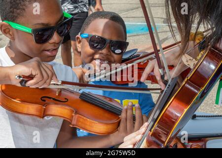 Detroit, Michigan - les garçons jouent le violon au stand Sphinx Overture lors d'un festival communautaire d'arts et de musique. L'organisation Sphinx a été fondée à un Banque D'Images