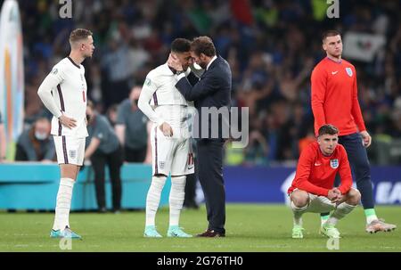 Gareth Southgate, le directeur de l'Angleterre, console Jadon Sancho après la défaite dans le tir de pénalité après la finale de l'UEFA Euro 2020 au stade Wembley, Londres. Date de la photo: Dimanche 11 juillet 2021. Banque D'Images