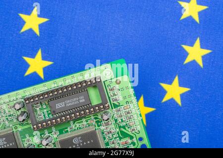 Drapeau UE avec carte de circuit imprimé verte avec prise EPROM vide. Pour 2021, pénuries de puces informatiques intégrées, pénuries de semi-conducteurs. Banque D'Images