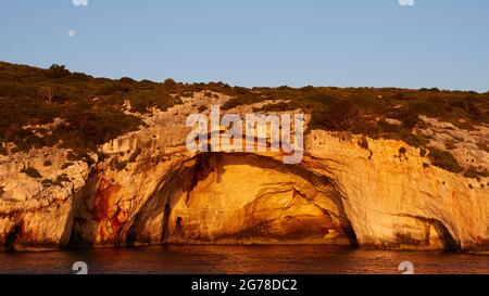 Îles Ioniennes, Zakynthos, côte nord-est, Grottes bleues, lumière du matin, ciel bleu, lune en haut à gauche de l'image, grande grotte au centre de l'image Banque D'Images