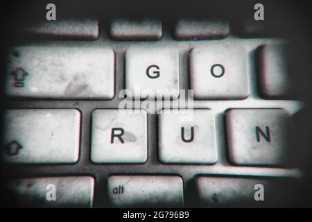 GO RUN s'affiche sur un ancien clavier d'ordinateur grubby Banque D'Images