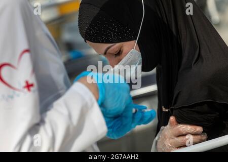 Moscou, Russie. 12 juillet 2021 UNE femme dans un hijab reçoit une injection du vaccin Gam-COVID-Vac (Spoutnik V) contre le nouveau coronavirus COVID-19 dans un pavillon en santé de Moscou établi au centre d'exposition Gostiny Dvor. C'est l'un des plus grands sites de vaccination de la COVID-19 en Europe Banque D'Images