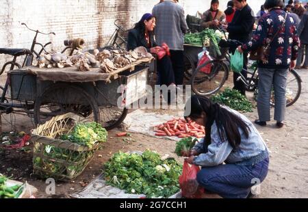 Kunden und Verkäufer auf einem Lebensmittelmarkt in der Stadt Xian, Chine 1998. Clients et vendeurs sur un marché dans la ville de Xian, Chine 1998. Banque D'Images