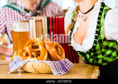 Le restaurant bavarois avec de la musique, les invités, les bretzels et bière de blé Banque D'Images