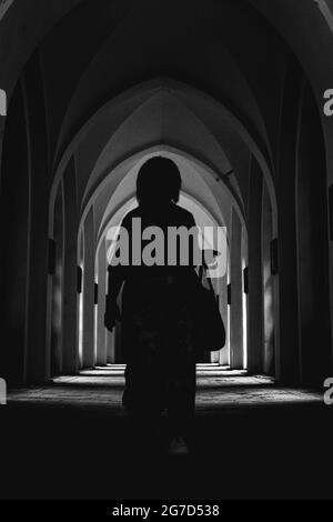 silhouette de femme dans le couloir du château, photographie en noir et blanc Banque D'Images