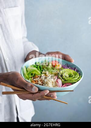 Buddha Bowl étant tenu dans les mains d'une personne Banque D'Images