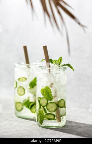 Boissons fraîches au concombre et à la menthe, limonade d'été froide. Concept de minimalisme moderne. Ombres ensoleillées Banque D'Images