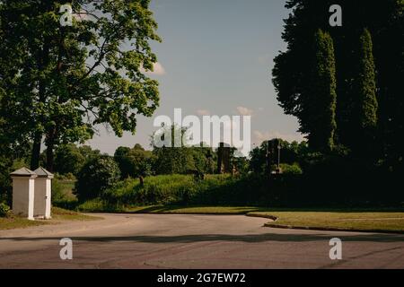 route de campagne menant près du cimetière et de la porte de l'église, jour ensoleillé d'été Banque D'Images