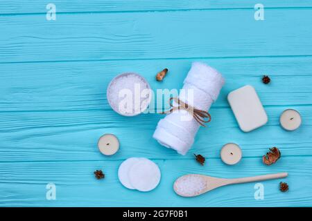 Serviette blanche avec sel et bougies sur table en bois bleu. Banque D'Images