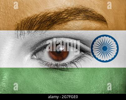 Jeune femme avec visage dans les couleurs de drapeau indien, gros plan Banque D'Images