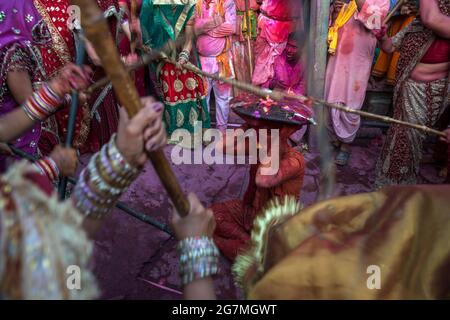 Les hommes de Barsana raid la ville voisine de Nandgaon et sont battus par les femmes de Nandgaon avec de grands bâtons et étalé avec des poudres de couleur Holi Banque D'Images