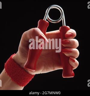 Jeune femme. Gros plan de la main à l'aide d'un exercice de poignée. Banque D'Images