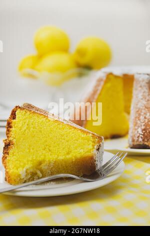 Gros plan d'un gâteau au citron sur fond de citrons juteux Banque D'Images