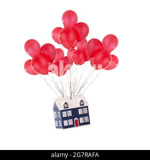 Maison de jouets flottant avec des ballons rouges isolés sur un fond blanc. Maison de déménagement et nouveau concept de maison pour les agents immobiliers Banque D'Images