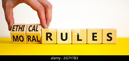 Symbole des règles éthiques ou morales. Homme d'affaires transforme les cubes en bois et les mots « règles éthiques » en « règles orales » sur un magnifique fond blanc. Busi Banque D'Images