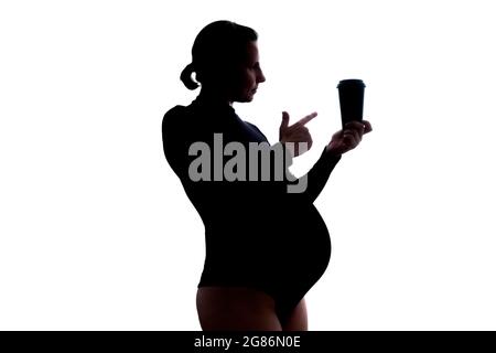 Femme enceinte avec une tasse de café. Vue latérale Banque D'Images