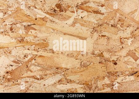 Texture du bois. Panneaux en bois OSB pour la décoration de fond. Texture du panneau OSB. Arrière-plan en bois marron. Motif simple en tableau de bord pressé. Banque D'Images