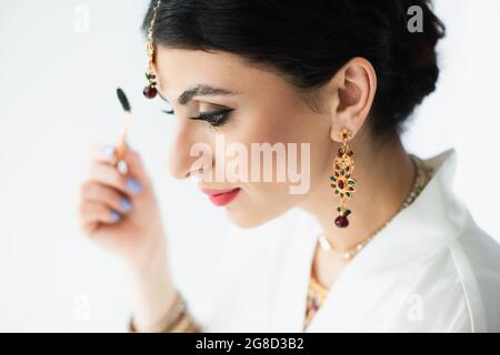 mariée indienne style sourcil avec pinceau cosmétique sur blanc Banque D'Images