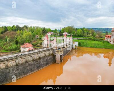 République tchèque, Talsperre les Kralovstvi (Royaume forestier) - 15 mai 2021. Vue aérienne du barrage historique d'eau hydraulique avec eau orange dans la rivière Elbe Banque D'Images