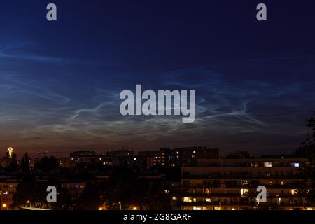 Nuage de Noctilucent (NLC, nuages de nuit) sur le projet de logement et l'église dans la soirée. Phénomènes ressemblant à un nuage dans la mésosphère. Ce sont les nuages les plus élevés dans E Banque D'Images