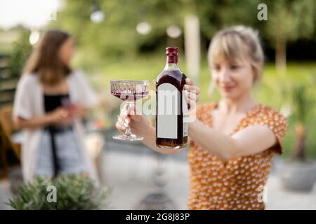 Femme avec de l'alcool sur un pique-nique à l'extérieur Banque D'Images