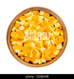 Peau d'orange biologique fraîche, coupée en morceaux carrés, dans un bol en bois. Peau carrée d'oranges, utilisée pour la cuisson ou séchée pour les mélanges de thé. Banque D'Images