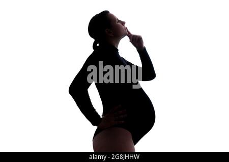 Femme enceinte pensive générant l'idée. Vue latérale de la silhouette Banque D'Images