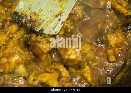 Préparation du curry de poulet indien chaud fumé, l'une des spécialités épicées des aliments indiens. L'Inde est célèbre pour ses plats savoureux colorés en Asie. Banque D'Images