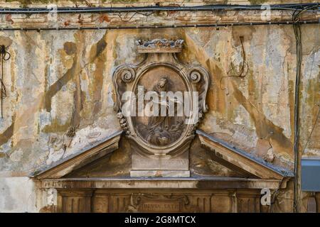 Vue rapprochée d'un ancien tympan en marbre représentant l'Immaculée Madonna dans le centre historique de Gênes, Ligurie, Italie Banque D'Images