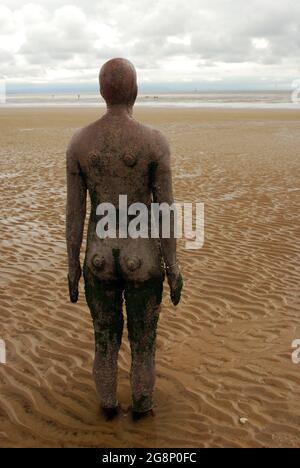 Statue d'Anthony Gormley avec vue sur la mer sur Crosby Beach à Merseyside, Angleterre, Royaume-Uni Banque D'Images