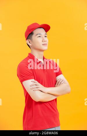Portrait de contenu attrayant virile gai Guy mailman bras pliés isolé sur fond jaune vif Banque D'Images