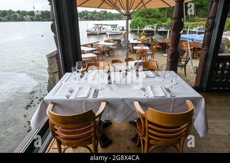 20 juillet 2021, Brandebourg, Potsdam: Le restaurant 'Kongsnaes - la gare impériale de Sailor' du Groupe Laggner à la Jungfernsee est construit en bois norvégien. Il sert principalement du poisson, principalement régional, ainsi que de la bouillabaise et des plats de saison. En 1890, le Kaiser Wilhelm II fit reconstruire sa station de voile sur la Jungfernsee de Potsdam dans le style dragon 'norvégien'. Après un incendie dans les jours de guerre. En 1945, les fortifications frontalières de la RDA se sont encouru le long de ce site. Avec l'aide de plans historiques et de photographies, la reconstruction du Ventehalle est devenue possible. Photo: Jens Kalaen Banque D'Images