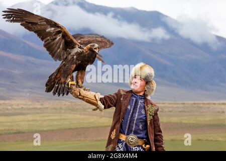 Chasseur d'aigle et son aigle d'or à Issyk Kul, Kirghizistan Banque D'Images