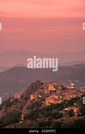 Soleil du soir sur l'ancien village de montagne de Speloncato dans la région de Balagne en Corse avec Cap Corse au loin Banque D'Images