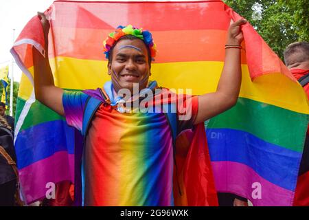 Londres, Royaume-Uni. 24 juillet 2021. Un manifestant détient un drapeau de la fierté sur la place du Parlement pendant la manifestation Real Pride.des milliers de personnes ont défilé dans le centre de Londres pour soutenir les droits, la diversité, l'inclusion et contre la transphobie croissante, et ce que beaucoup considèrent comme la commercialisation de la marche de la fierté annuelle. Crédit : SOPA Images Limited/Alamy Live News Banque D'Images