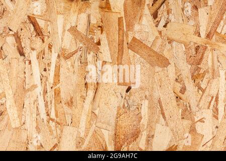 Texture du bois. Panneaux en bois OSB pour la décoration de fond. Texture du panneau OSB. Arrière-plan en bois marron. Motif simple en tableau de bord pressé. Banque D'Images