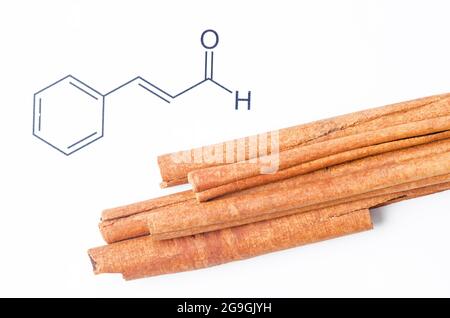 Cannelle aromatique et cinnamaldéhyde, structure chimique et formule. Composé organique qui donne à la cannelle sa saveur et son odeur. Banque D'Images