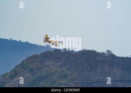 Oristano, Sardina, Italie. 26 juillet 2021. Un avion de lutte contre les incendies survole une zone brûlée à Oristano, en Sardaigne, en Italie, le 26 juillet 2021. Les services régionaux d'urgence de la Sardaigne ont émis lundi un nouvel avertissement de mauvais temps et le gouvernement régional a déclaré l'état d'urgence après que de grandes portions de l'île principale ont été ravagées par des feux de forêt au cours des derniers jours. (Xinhua) Credit: Xinhua/Alay Live News Banque D'Images