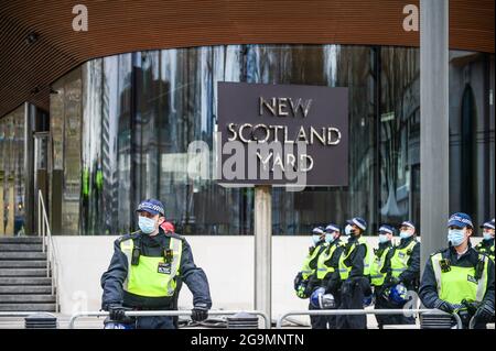 Des officiers masqués sont en garde à New Scotland Yard Yard, à Londres, au Royaume-Uni Banque D'Images