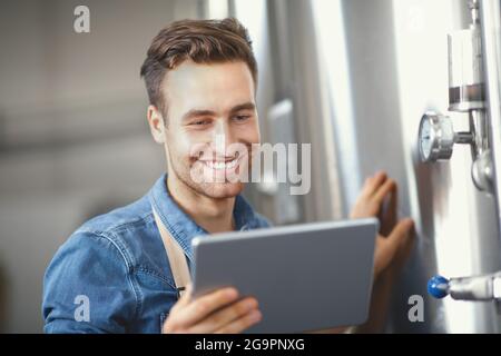 Entreprise prospère, travail en usine, brasserie avec appareil numérique Banque D'Images