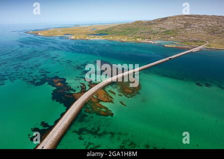 Vue aérienne depuis le drone de la chaussée d'Eriskay reliant les îles de South Uist (en haut) à Eriskay dans les Hébrides extérieures, en Écosse, au Royaume-Uni Banque D'Images