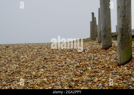 Un paysage de front de mer brumeux et brumeux au stade de Hastings, dans l'est du Sussex, en Angleterre, avec son cadre métallique victorien bordant les plages Banque D'Images