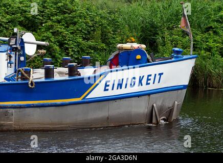 Kleinmachnow, Allemagne. 22 juillet 2021. La barge 'MS EINIGKEIT' (Hambourg) quitte l'écluse de Kleinmachnower dans le canal de Teltow. Le canal de Teltow s'étend sur environ 38 kilomètres à travers le Brandebourg et Berlin et est un important contournement sud de Berlin pour la navigation commerciale et une destination populaire pour les campeurs, les touristes de bateau et aussi les randonneurs. À Dreilinden, par exemple, il y a des voies plus ou moins étroites pour les piétons près de la rive du canal jusqu'à Machnower See. Credit: Soeren Stache/dpa-Zentralbild/ZB/dpa/Alay Live News Banque D'Images