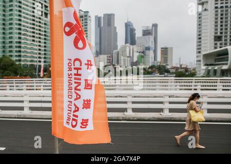 Makati, Philippines. 29 juillet 2021. Une femme marche sur le pont Estrella-Pantaléon (EP), financé par la Chine, à Makati, aux Philippines, le 29 juillet 2021. Le pont EP au-dessus de la rivière Pasig est un pont de poutres en béton à deux voies et quatre voies en forme de V qui relie les villes de Makati et Mandaluyong, deux grandes villes de la région métropolitaine de Manille. On estime que 50,000 véhicules passent par le pont par jour. Crédit: Rouelle Umali/Xinhua/Alamy Live News Banque D'Images