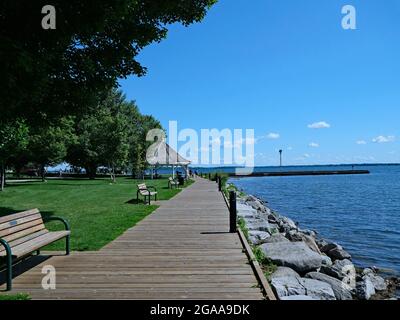 Parc public avec promenade le long d'un lac par une belle journée d'été Banque D'Images