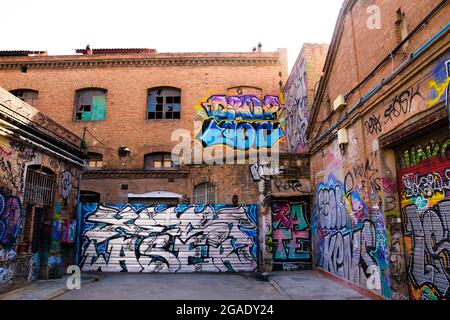 Graffitis sur les murs de briques rouges d'une ancienne usine. Banque D'Images