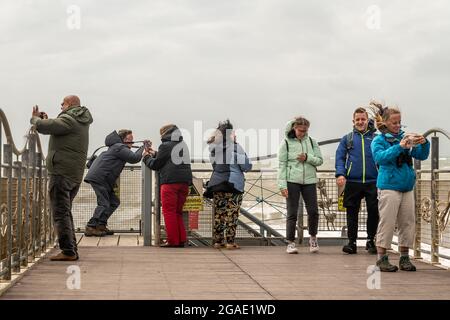 Holiday Makers Brace Force 6 gale conditions sur la côte et Birling Gap alors que Storm Evert frappe le sud-est. Birling Gap, East Sussex, Royaume-Uni. Banque D'Images