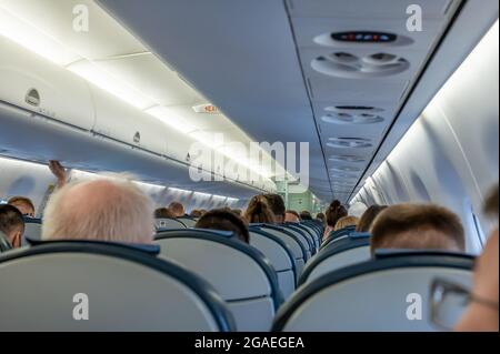 Dans la cabine de l'avion. Passagers dans la cabine de l'appareil. Cabine d'avion commerciale avec rangées de sièges dans l'allée. Cabine de moderne Aircra Banque D'Images