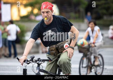 Ljubljana, Slovénie. 30 juillet 2021. Un manifestant sur un vélo envoie un sifflet en portant un T-shirt qui dit « Je me sens révolte », un spin-off du slogan touristique officiel slovène « Je me sens Slovénie », lors des manifestations cyclistes du vendredi contre le gouvernement du Premier ministre, Janez Jansa. Crédit : SOPA Images Limited/Alamy Live News Banque D'Images